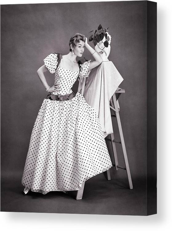 B&w Black And White 1950s Adult Attire Attractive Beauty Caucasian Celebration Clothes Fashion Fashionable Dress Fashionably Dressed Female Formal Dress Full-length Fun Glamorous Gown Indoors Ladder Lady Leaning Lifestyle Looking At Camera Luxury Mid-adult Woman Modeling Model Occupations Person Polka Dot Polka Dots Polka Portrait Pose Posing Sexy Step Ladder Studio Shot Stylish Urban Woman Young Adult Woman Young Adult Retro Vintage Nostalgia Nostalgic Old Fashioned Old Fashion Old Time Classic Canvas Print featuring the photograph 1950s Attractive Glamorous Woman Model In Stylish Polka Dot Gown Formal Dress Posing by Panoramic Images