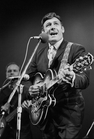 Charles playing the guitar and singing.