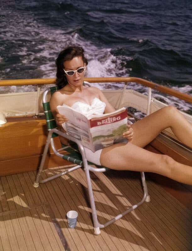 Woman reading a magazine on a boat